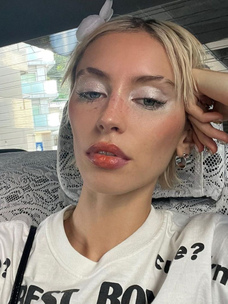 Iris Law with white pearly eyeshadow and glossed lips