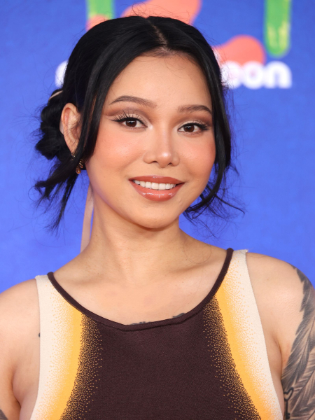 Bella Poarch with neutral brown crease shadow and glossed lips